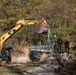 KFOR Swiss Army engineers construct a pedestrian bridge over the Ibar River