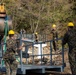 KFOR Swiss Army engineers construct a pedestrian bridge over the Ibar River