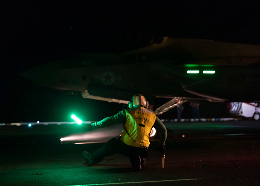 A Sailor Prepares to Launch a F-35C Lightning II aboard Nimitz-class aircraft carrier USS Carl Vinson (CVN 70)