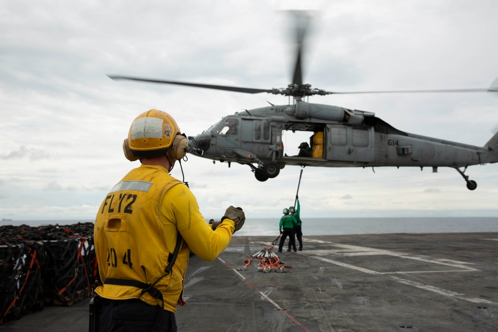 Abraham Lincoln conducts a replenishment-at-sea with USNS Rappahannock