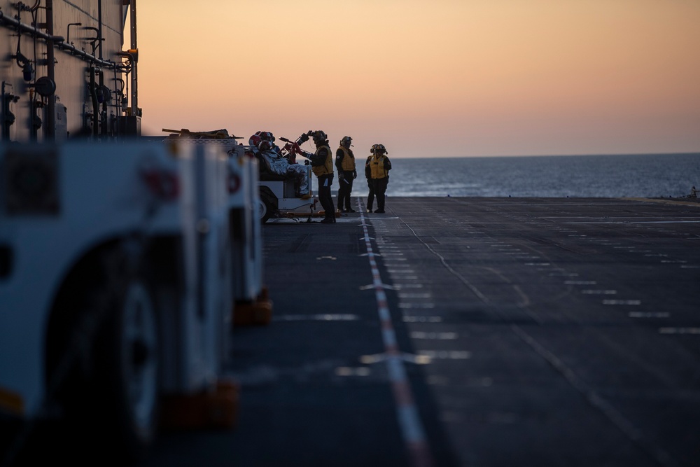 Sailors and Coast Guardsman medically evacuate a Sailor