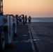 Sailors and Coast Guardsman medically evacuate a Sailor