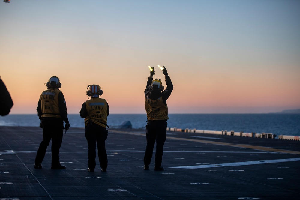 Sailors and Coast Guardsman medically evacuate a Sailor