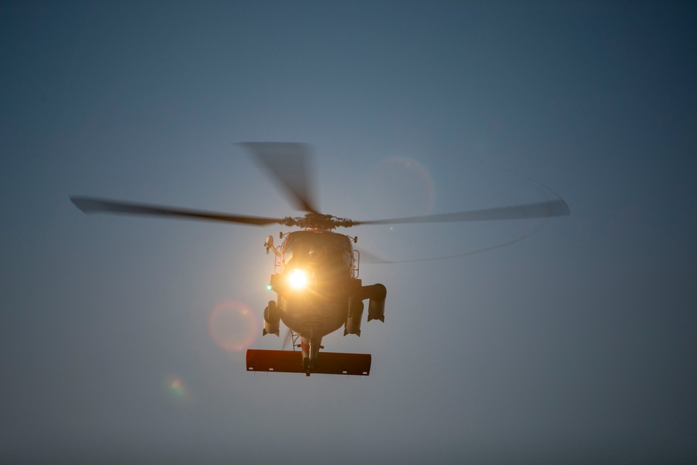 Sailors and Coast Guardsman medically evacuate a Sailor