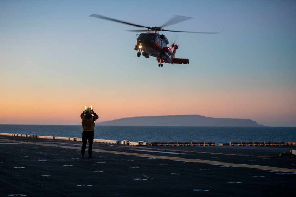 Sailors and Coast Guardsman medically evacuate a Sailor