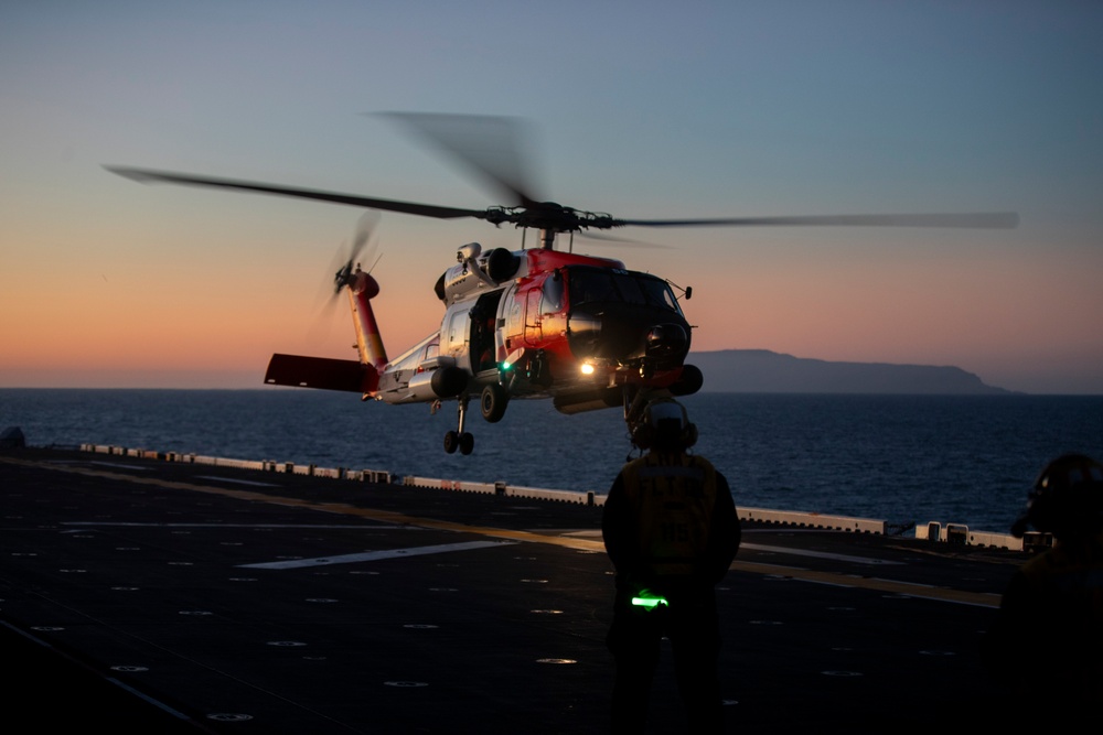 Sailors and Coast Guardsman medically evacuate a Sailor