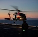 Sailors and Coast Guardsman medically evacuate a Sailor