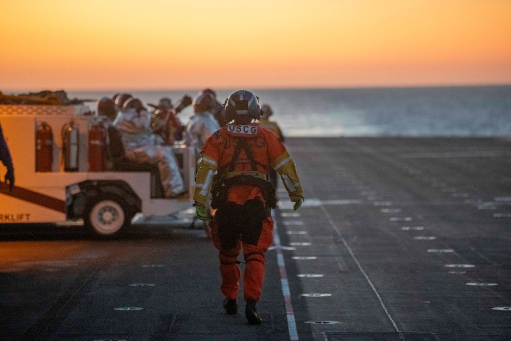 Sailors and Coast Guardsman medically evacuate a Sailor