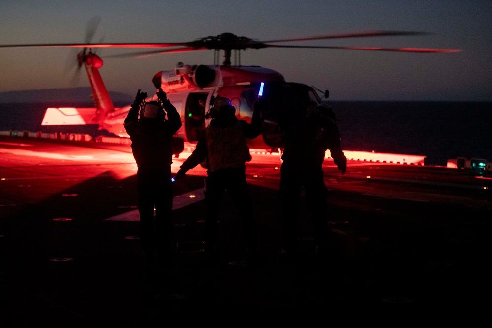 Sailors and Coast Guardsman medically evacuate a Sailor