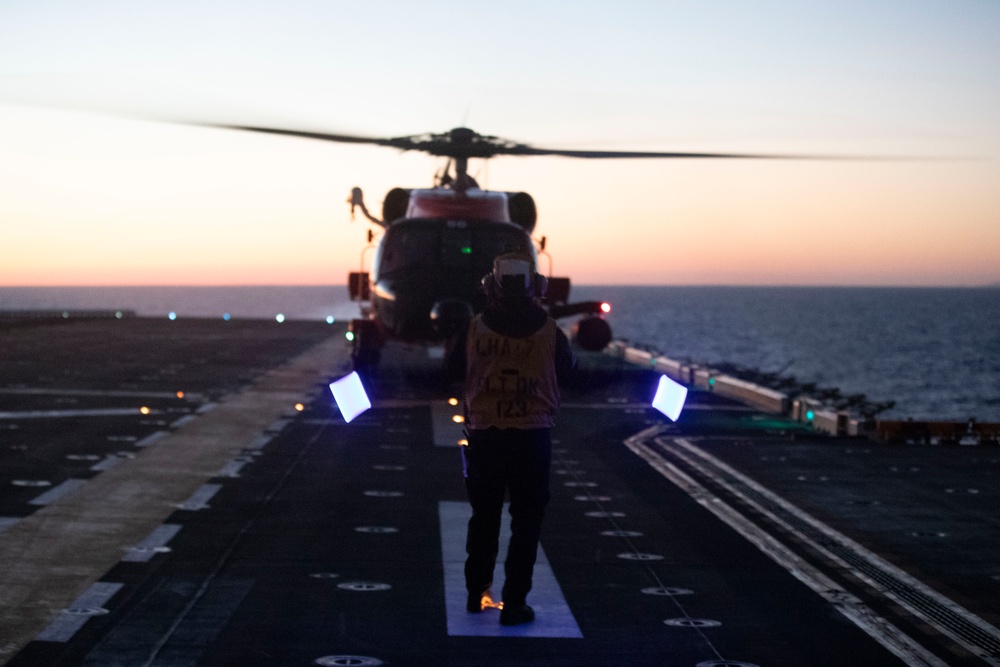 Sailors and Coast Guardsman medically evacuate a Sailor