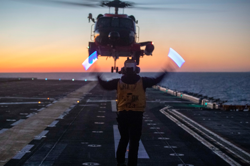 Sailors and Coast Guardsman medically evacuate a Sailor