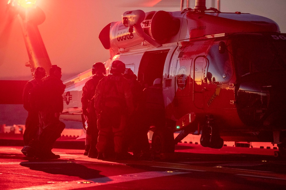 Sailors and Coast Guardsman medically evacuate a Sailor