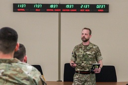 U.K. Maj. Christopher Wiggins, 3rd U.K. Division briefs Allied military and civilian planners