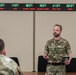 U.K. Maj. Christopher Wiggins, 3rd U.K. Division briefs Allied military and civilian planners