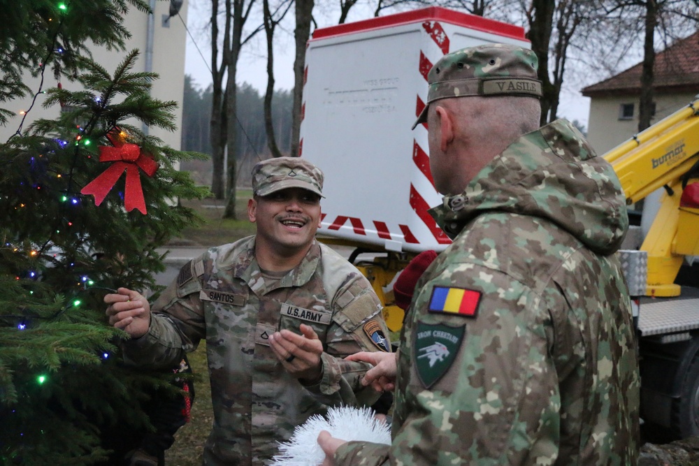 Forward Stationed Soldiers in Bemowo Piskie, Poland, decorate the base Christmas tree in celebration of the Holidays December 2, 2024