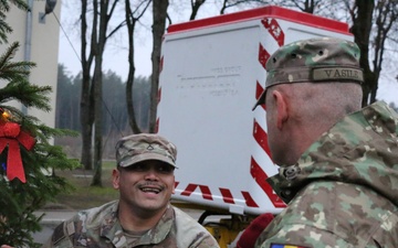 Forward Stationed Soldiers in Bemowo Piskie, Poland, decorate the base Christmas tree in celebration of the Holidays December 2, 2024