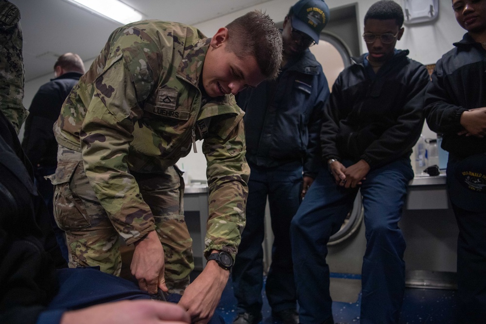 U.S. Army Soldiers assist with TCCC Training Aboard USS Ronald Reagan (CVN76)