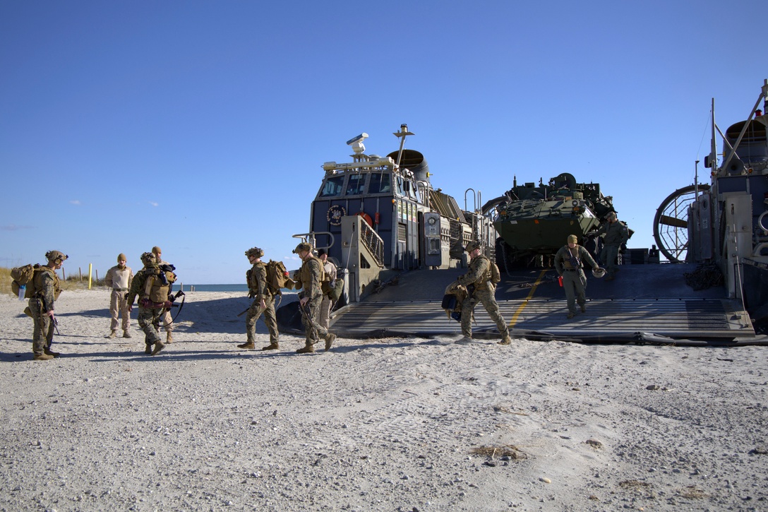 U.S. Marines with the 24th Marine Expeditionary Unit (Special Operations Capable) walk across the beach after finally returning home, Onslow Beach, North Carolina, Dec. 2, 2024. The Marines with the 24th MEU (SOC) return to Camp Lejeune following a 7-month long deployment to U.S. Naval Forces Europe and Africa area of operation. Embarked on the Navy’s Wasp Amphibious Ready Group, the 24th MEU (SOC) supported U.S. Allied, and partner interests in the region, including the Eastern Mediterranean Sea, to promote regional stability and deter aggression. (U.S. Marine Corps photo by Sgt. Michele Clarke)