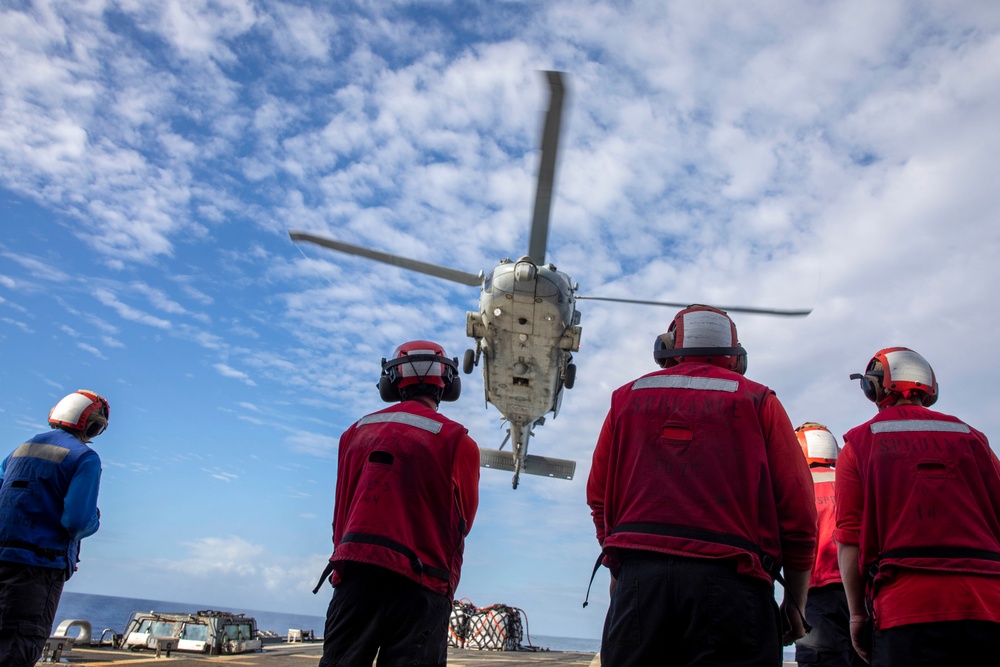USS Spruance conducts a vertical replenishment with the USNS Caesar Chavez