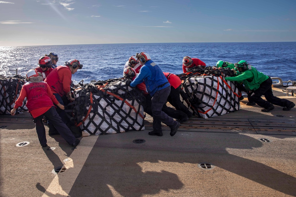 USS Spruance conducts a vertical replenishment with the USNS Caesar Chavez
