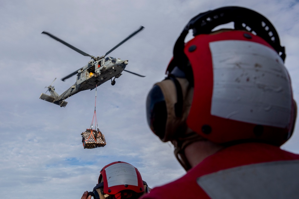 USS Spruance conducts a vertical replenishment with the USNS Caesar Chavez