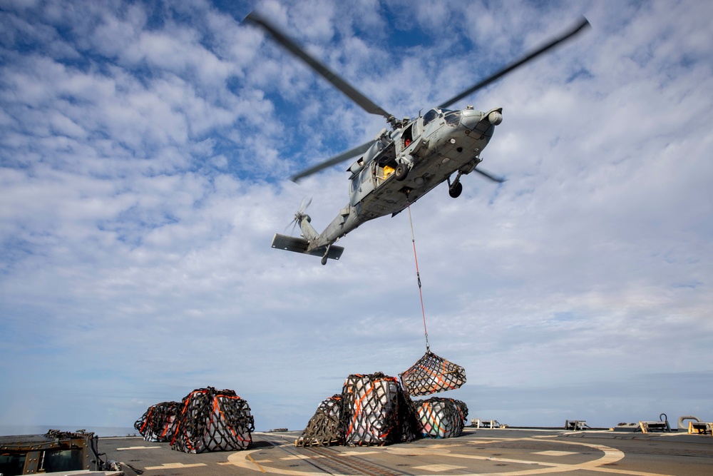 USS Spruance conducts a vertical replenishment with the USNS Caesar Chavez