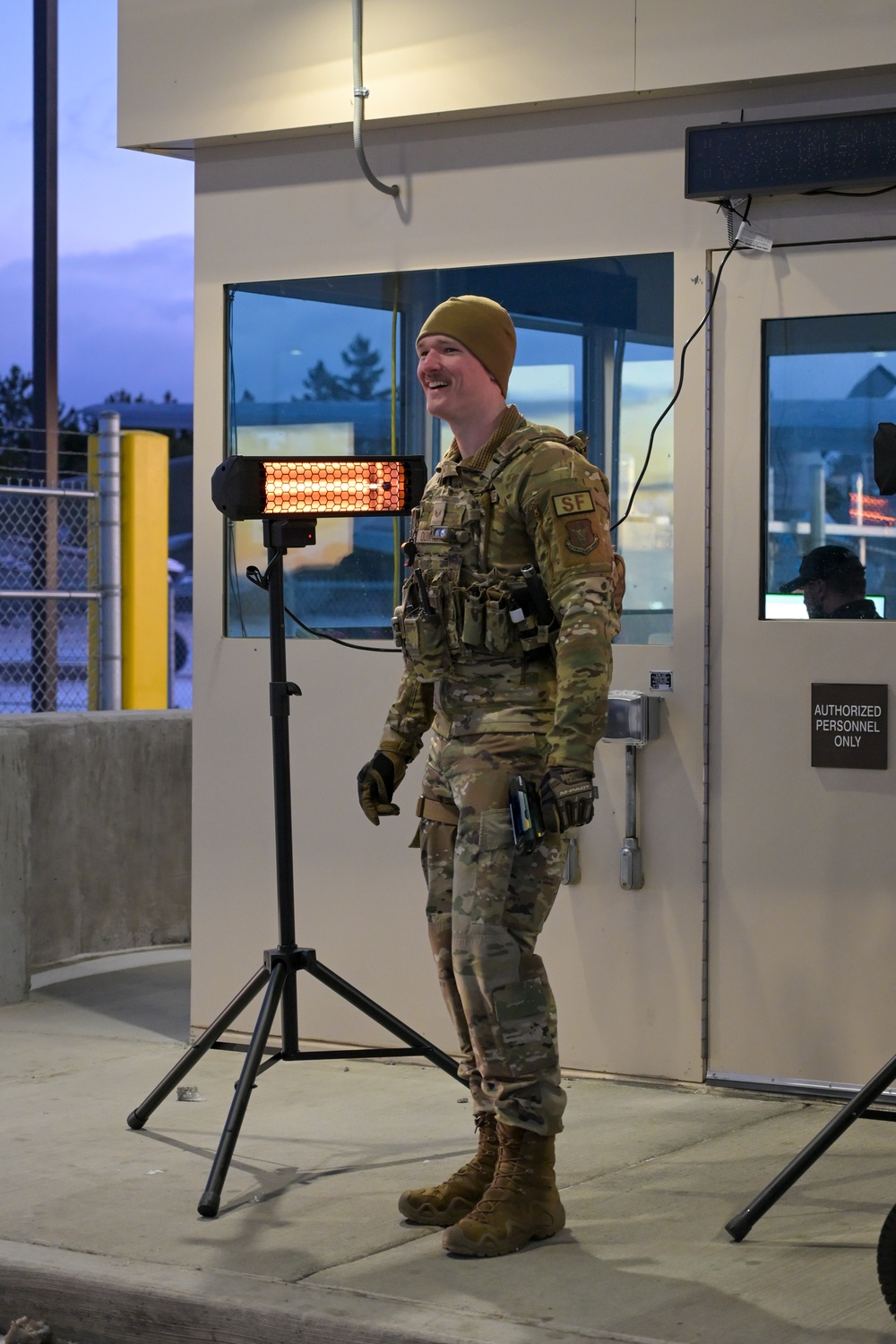 914th Security Forces Squadron Senior Airman checks identification cards at main gate