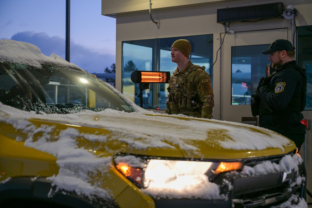 914th Security Forces Squadron Senior Airman checks identification cards at main gate