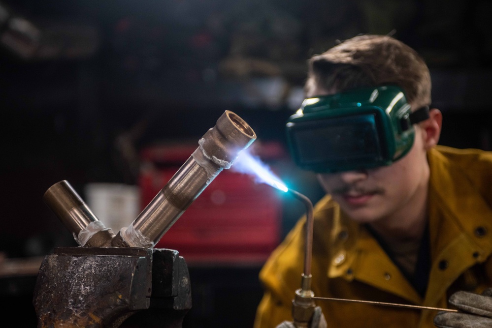 USS Ronald Reagan (CVN 76) Sailors practice welding