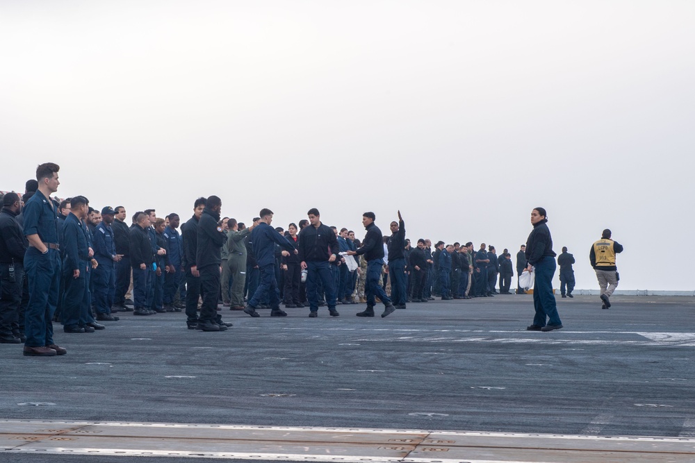 USS Ronald Reagan (CVN 76) Sailors and U.S. Army Soldiers participate in a FOD walk down
