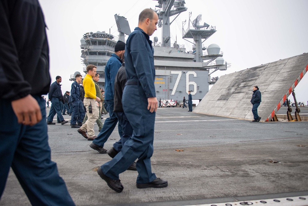 USS Ronald Reagan (CVN 76) Sailors and U.S. Army Soldiers participate in a FOD walk down