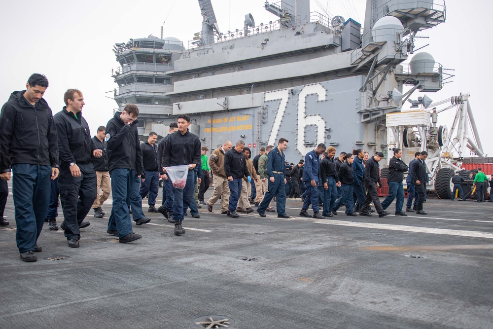 USS Ronald Reagan (CVN 76) Sailors and U.S. Army Soldiers participate in a FOD walk down