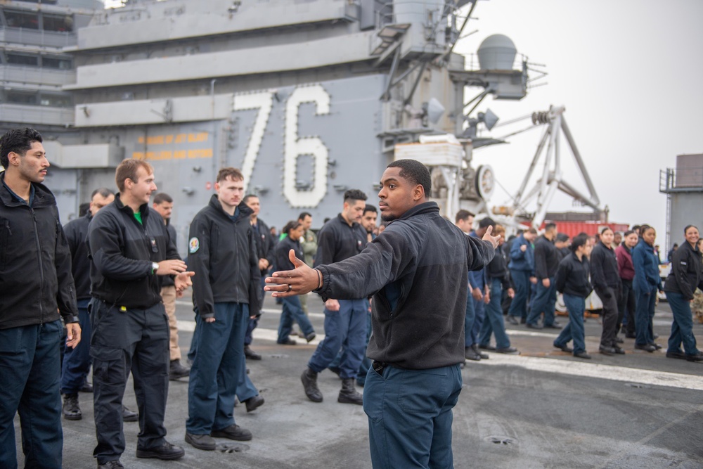 USS Ronald Reagan (CVN 76) Sailors and U.S. Army Soldiers participate in a FOD walk down