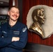 USS Ronald Reagan (CVN 76) Sailor poses with Ronald Reagan plaque