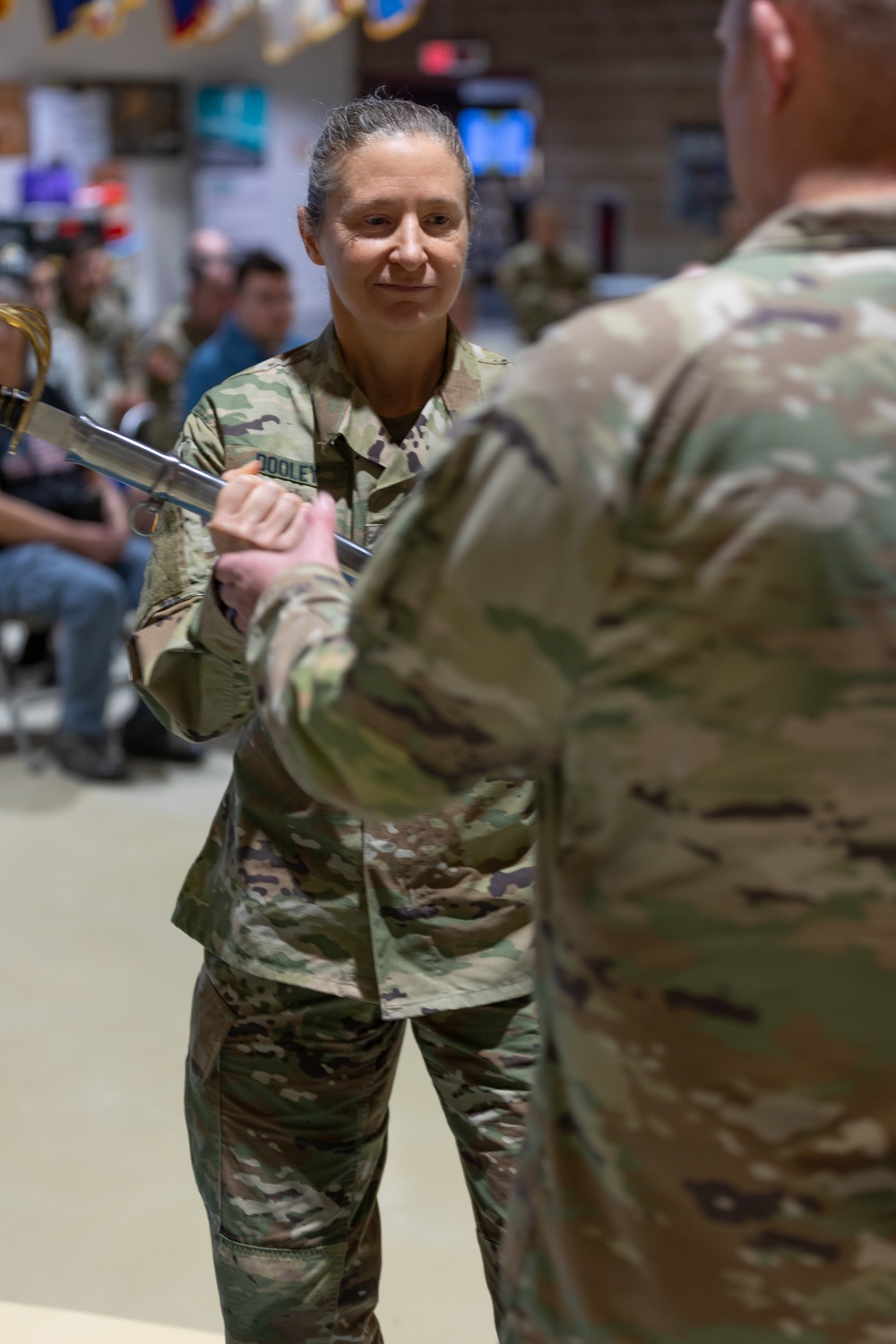 Chief Warrant Officer 5 Tracy Dooley passes the saber