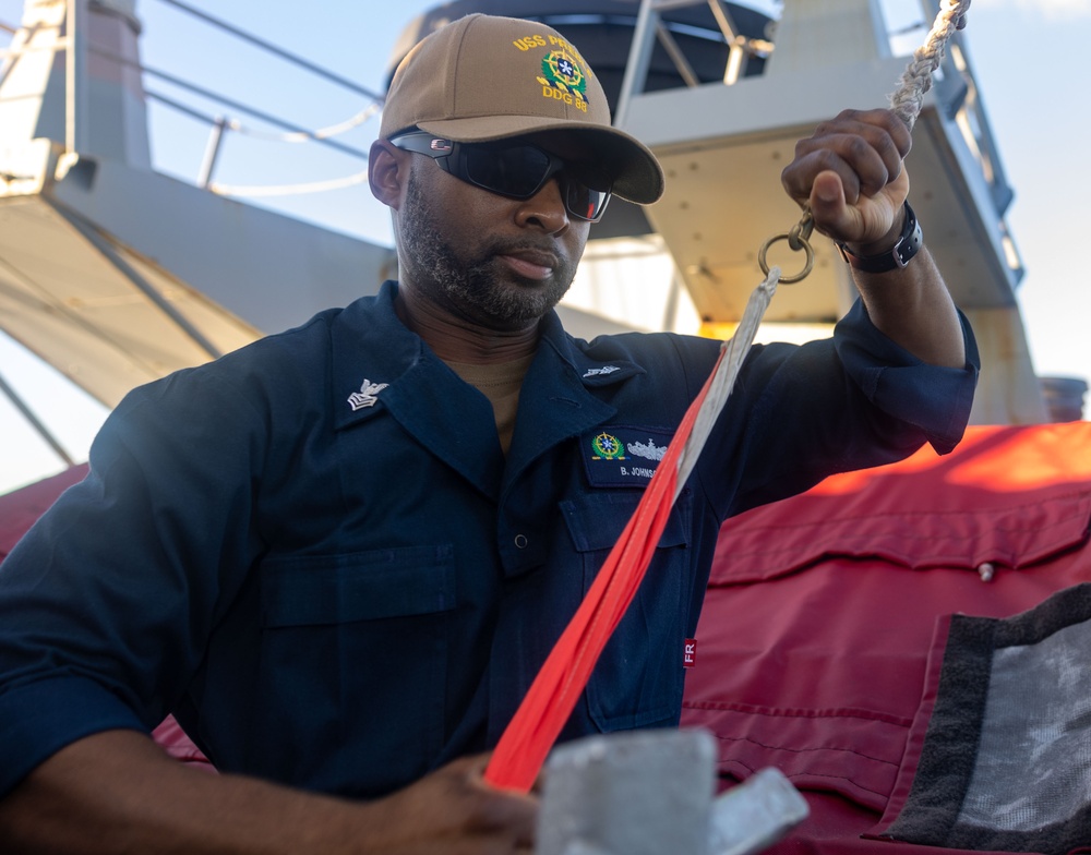 QM1 Byron Johnson Prepares to Hoist Bravo Flag