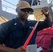 QM1 Byron Johnson Prepares to Hoist Bravo Flag
