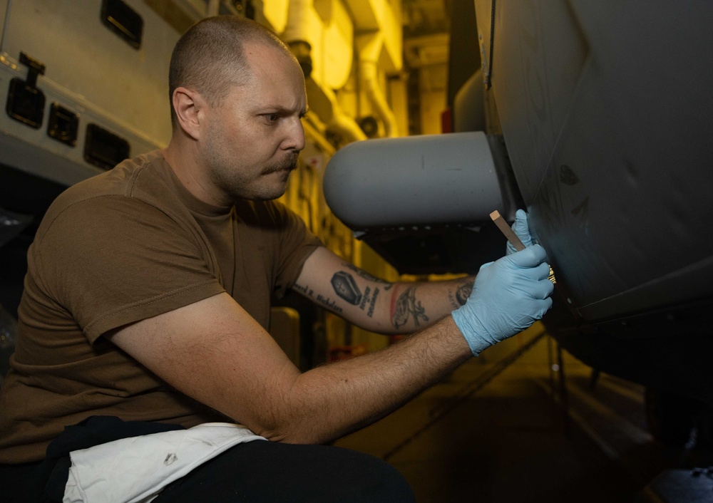 ADAN Chase Nicholson Conducts Corrosion Control Maintenance On MH-60R Sea Hawk