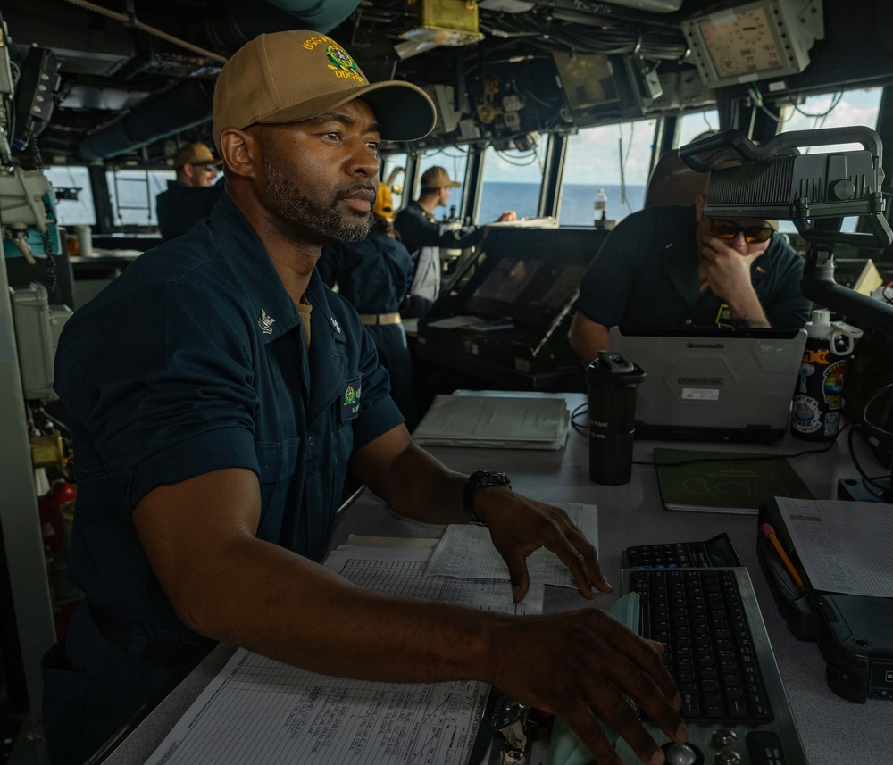 QM1 Byron Johnson Monitors Ship's Track On VMS