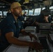 QM1 Byron Johnson Monitors Ship's Track On VMS