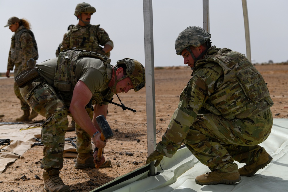 U.S. Airmen build tents during tactical airfield exercise