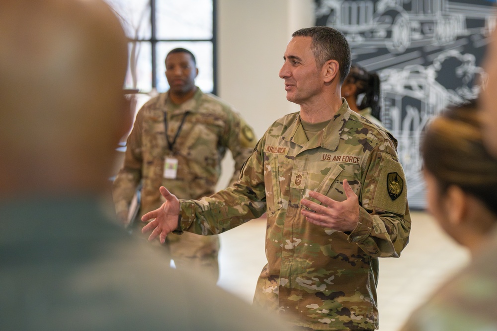 CMSgt. Brian Kruzelnick coins Airmen