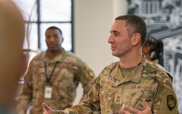 CMSgt. Brian Kruzelnick coins Airmen