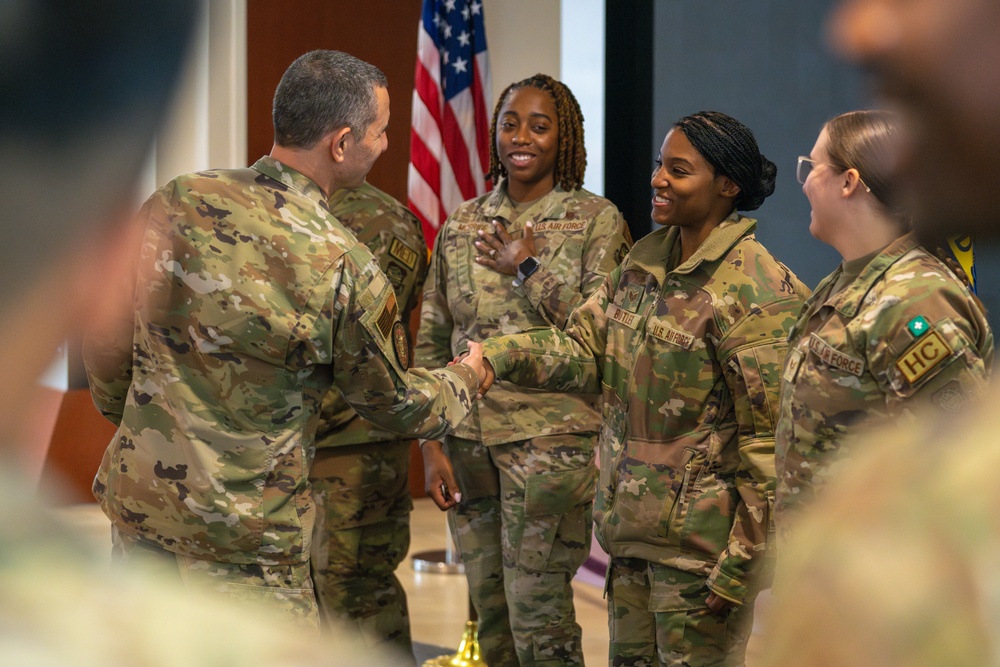 CMSgt. Brian Kruzelnick coins Airmen