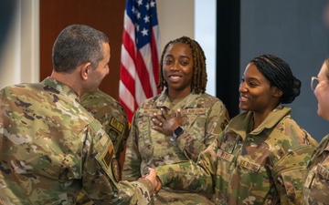 CMSgt. Brian Kruzelnick coins Airmen