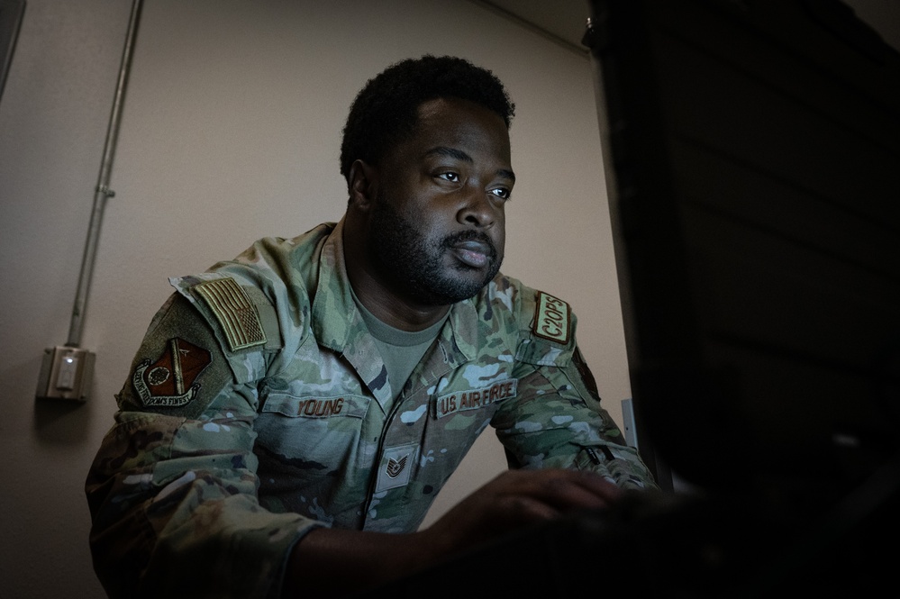 U.S. Air Force Tech. Sgt. Traylon Young, 377th Air Base Wing Command Post non-commissioned officer in charge NC2 Operations Training, interacts with Global Aircrew Strategic Network Terminal