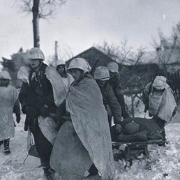 Army Paratroopers in WW II Battle of the Bulge Drag Wounded Buddy to Aid