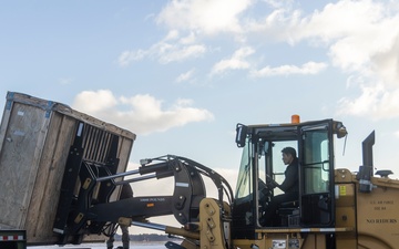 Japanese forces assist U.S. Marines with transporting equipment