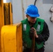 USS Ronald Reagan (CVN 76) Sailors transport gear on the flight deck