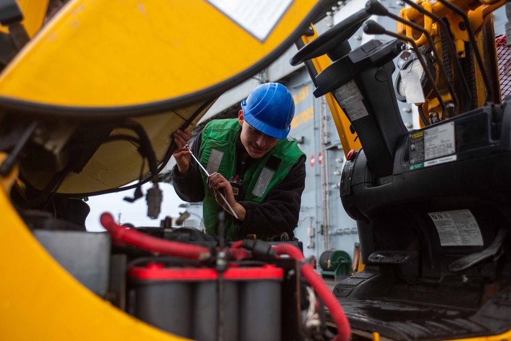 USS Ronald Reagan (CVN 76) Sailors transport gear on the flight deck